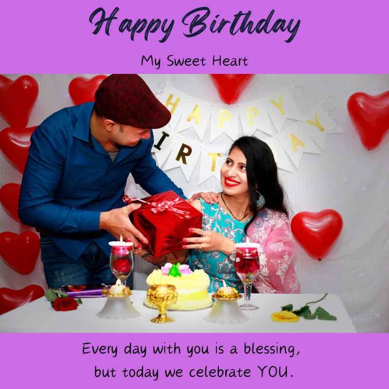 Couple celebrating birthday with cake, gift, and heart balloons.