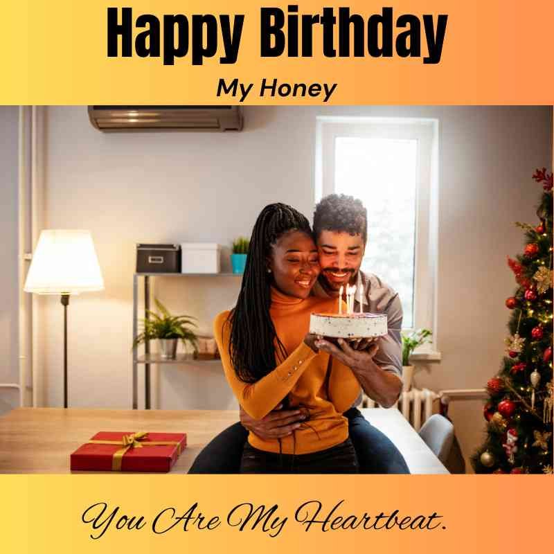 Man surprising his partner with a birthday cake near a Christmas tree.