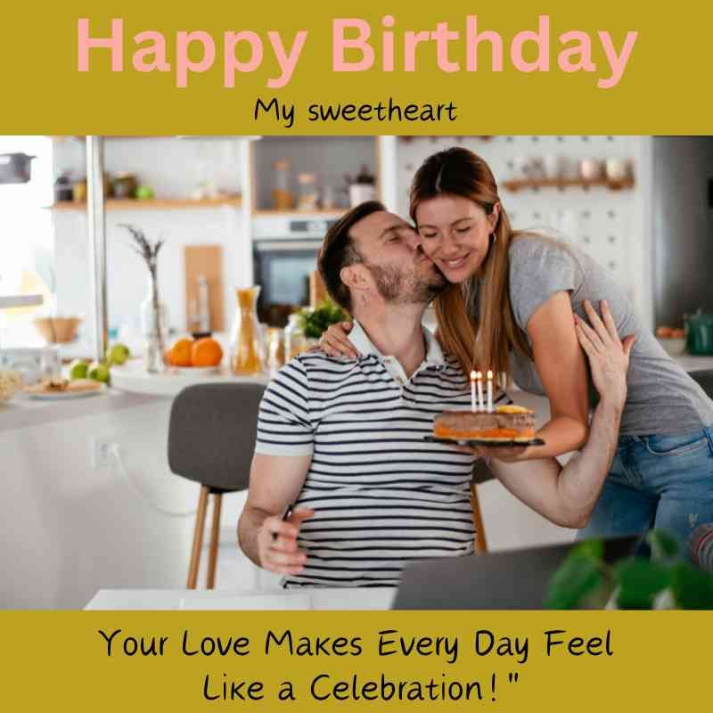 Woman kissing man on the cheek while serving birthday cake in a cozy kitchen.