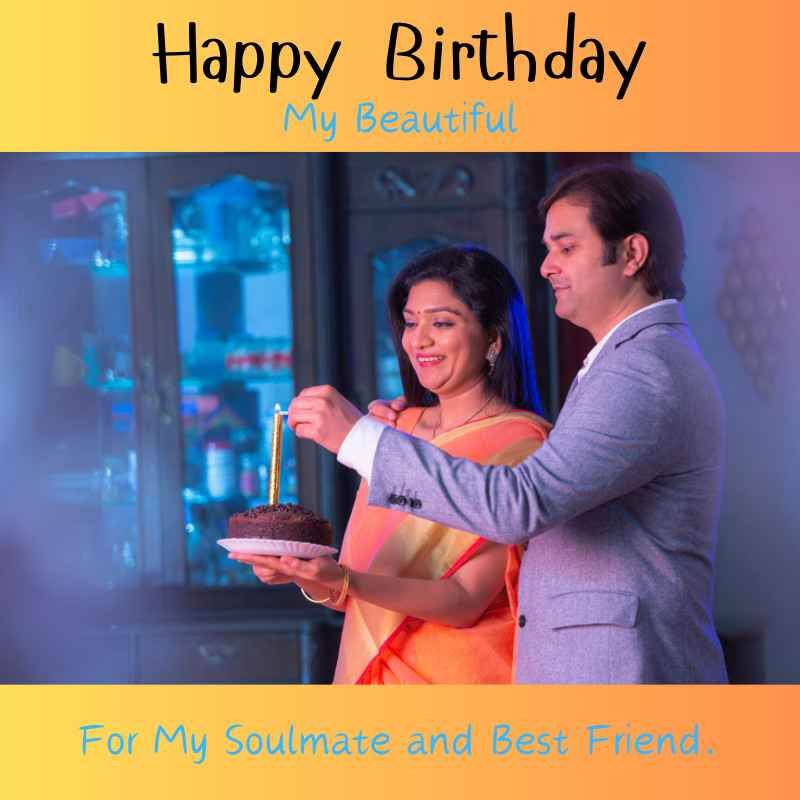 Couple celebrating birthday with cake and candles in a heartfelt moment.
