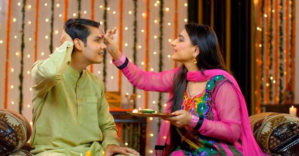 Sister applying tilak on her brother’s forehead during Raksha Bandhan celebration