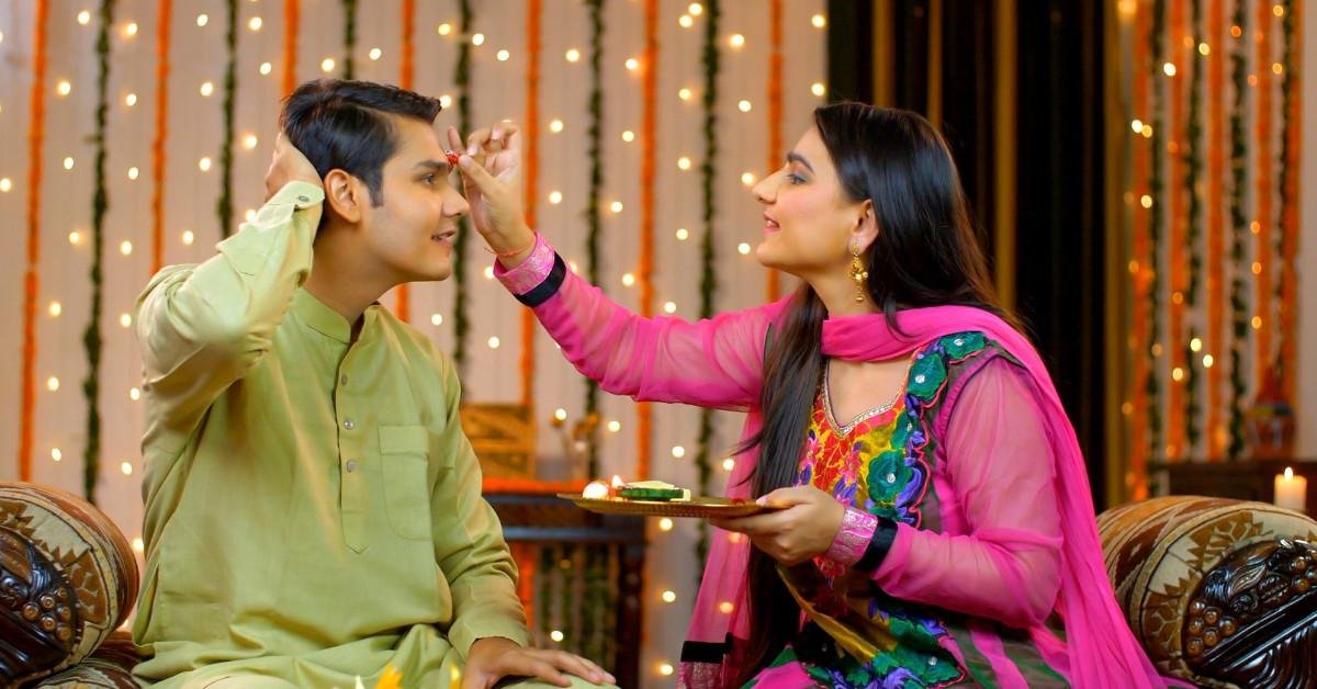 Sister applying tilak on her brother’s forehead during Raksha Bandhan celebration