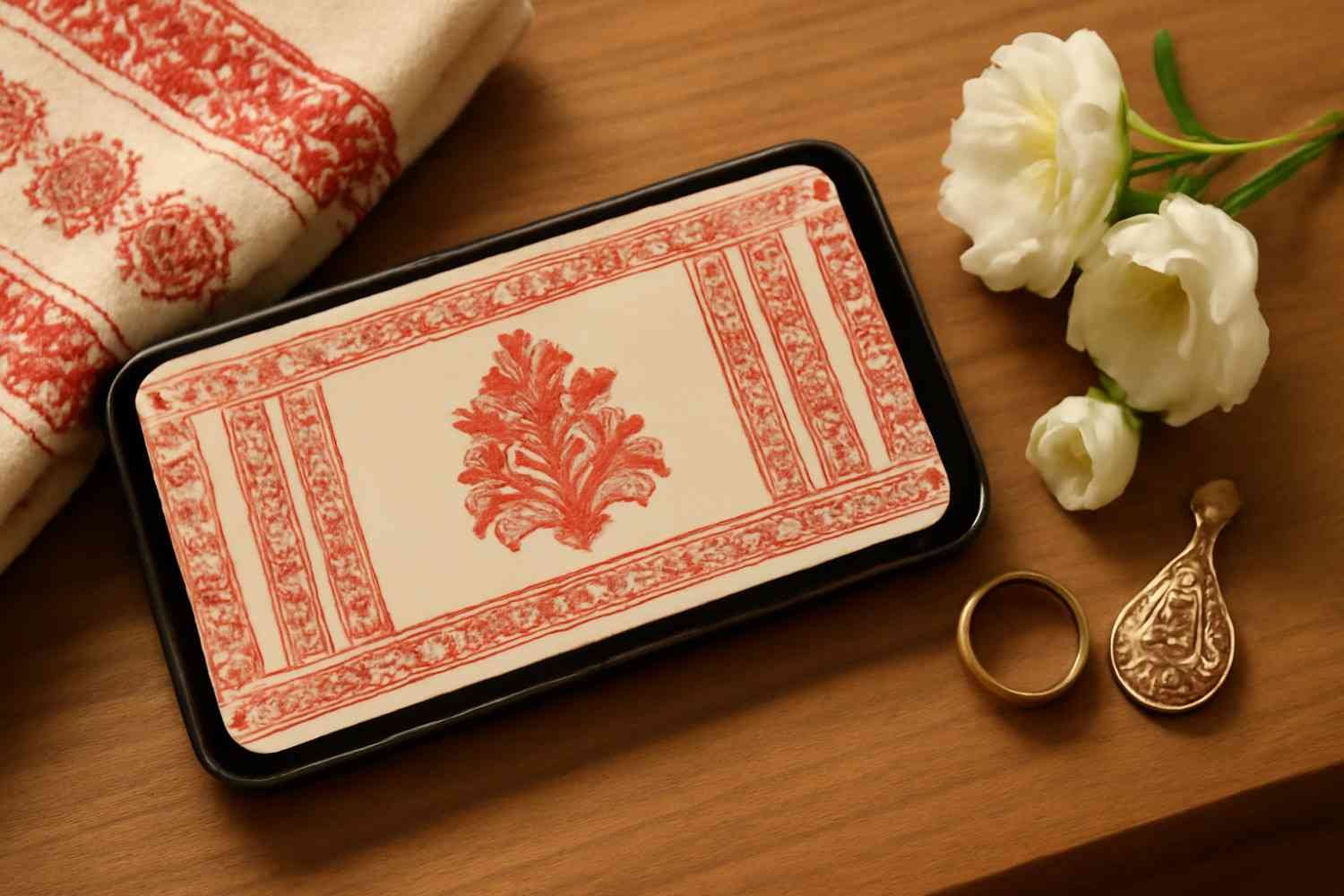Digital Assamese marriage invitation card displayed on a smartphone with traditional Assamese decorations