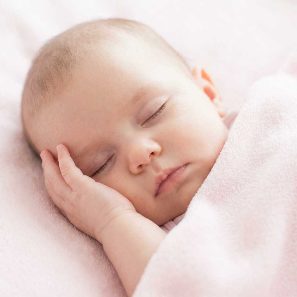 Baby girl light sleep hand on cheek profile
