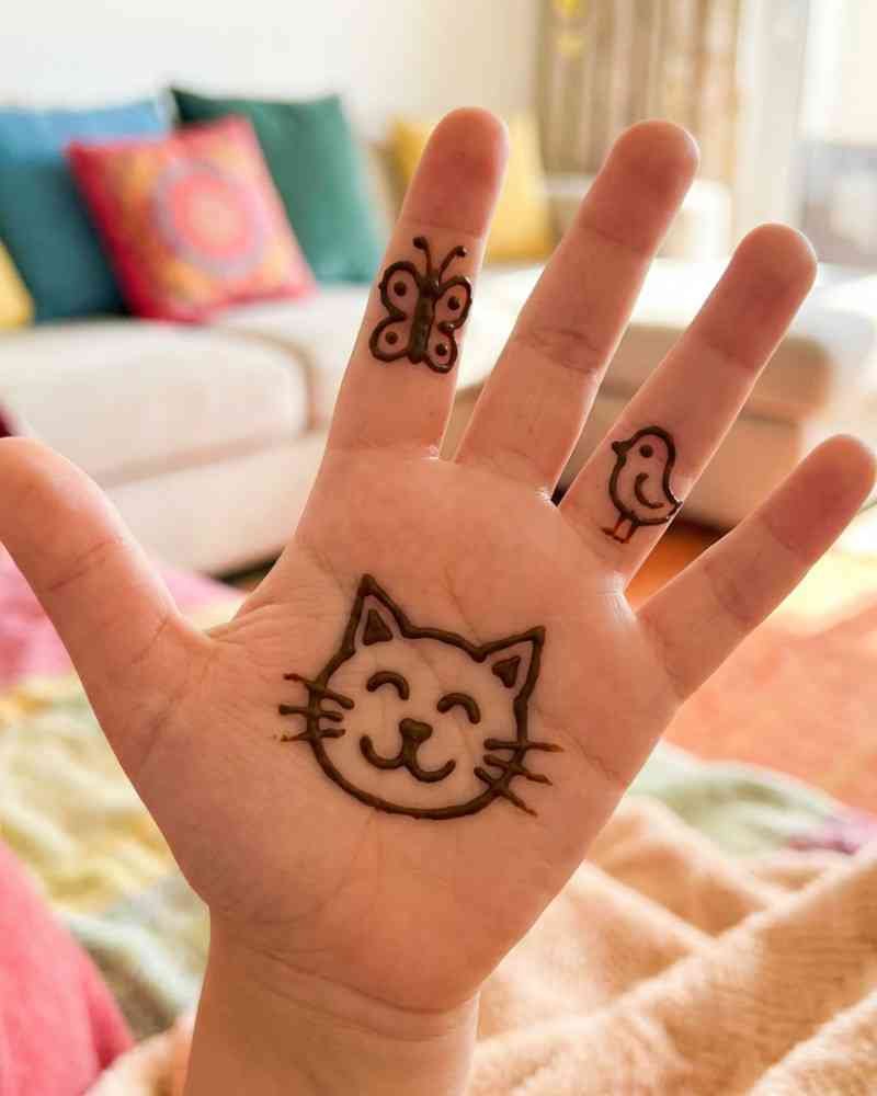 Cute cat face mehndi design on front hand for kids Eid