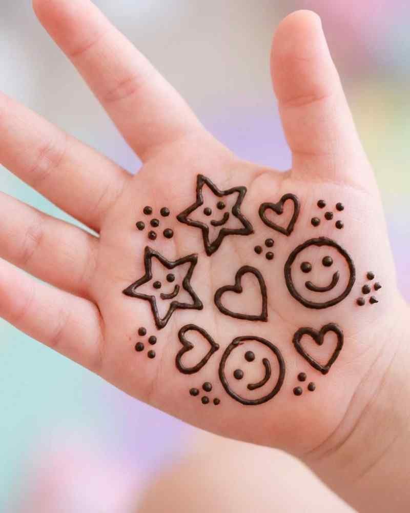 Simple smiley and heart mehndi design on front hand for kids Eid