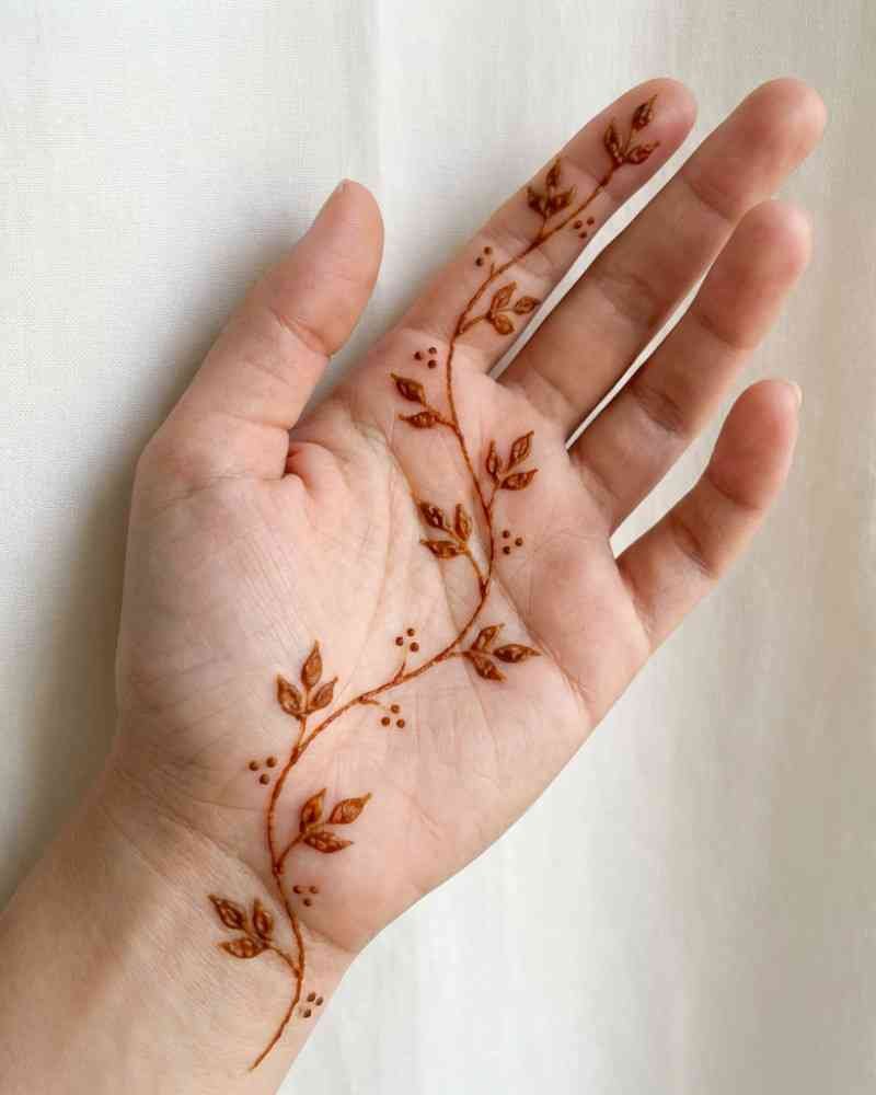 Minimal Arabic vine mehndi design on front hand for Eid celebration
