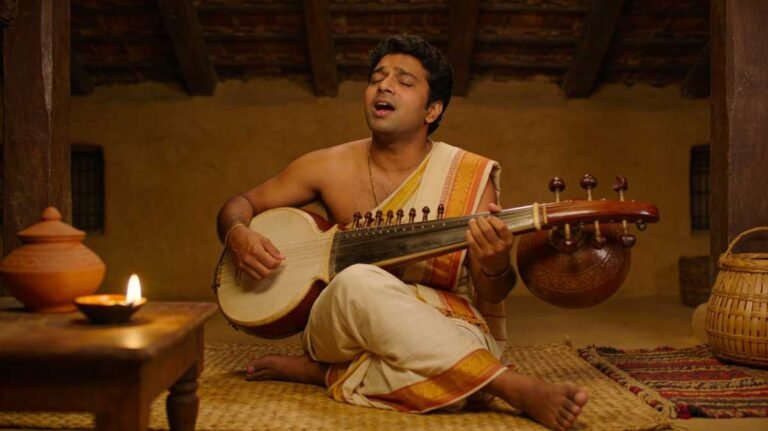 Assamese singer performing emotional love song with tokari instrument