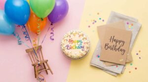 • : Short birthday wishes written on a birthday card surrounded by balloons and cake