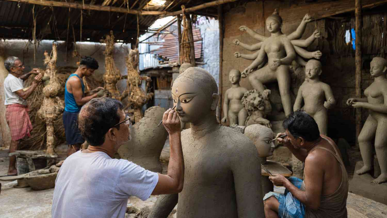 Bengali artisans creating a traditional Durga idol with straw, bamboo and clay in Kumartuli