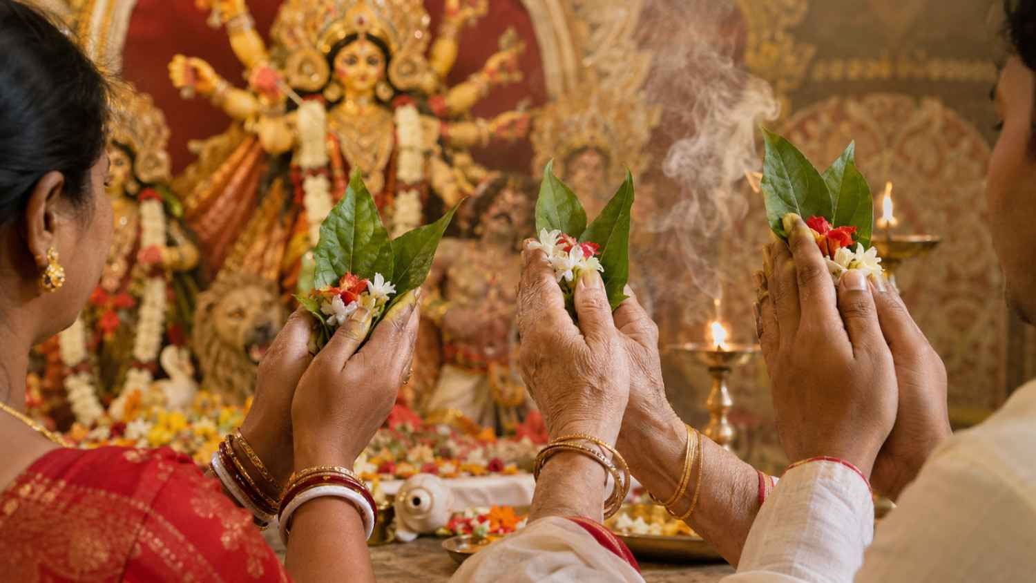 Durga Puja Anjali Mantra recited while devotees hold flowers and bel leaves before Maa Durga